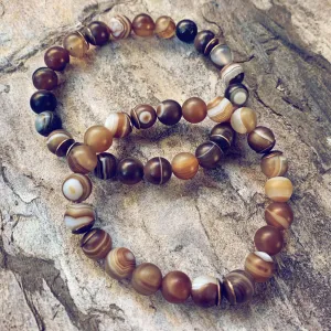 stability II // brown line agate and natural brass mala bead bracelet